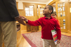 Pre-K shaking hands in library